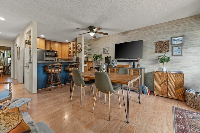 1299 Uluniu Rd Unit 103E, Kihei, HI 96753 - dining room featuring a ceiling fan, light wood-type flooring, recessed lighting, and a textured ceiling