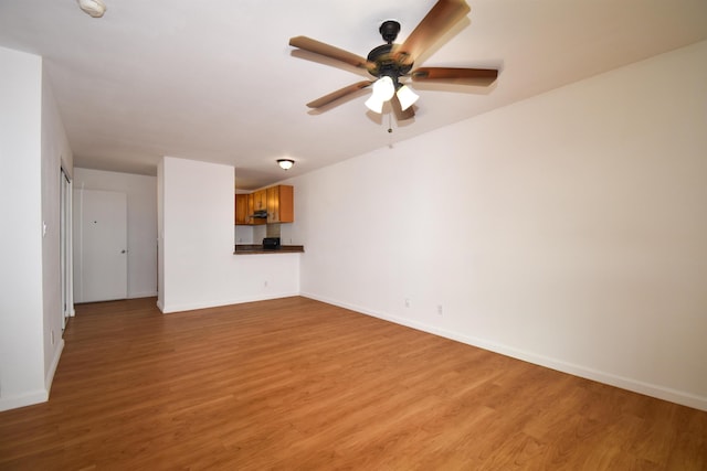 unfurnished living room with ceiling fan and light hardwood / wood-style flooring