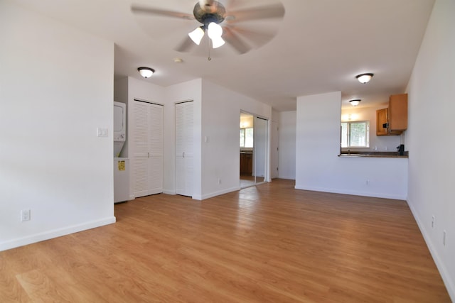 unfurnished living room featuring light hardwood / wood-style floors, a healthy amount of sunlight, and ceiling fan