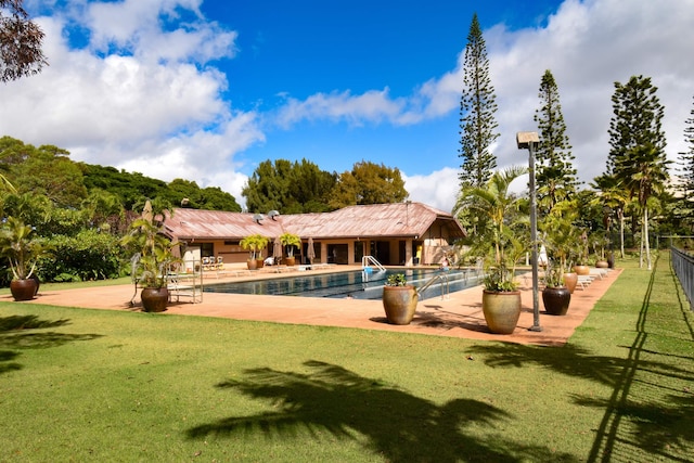 view of swimming pool with a lawn and a patio