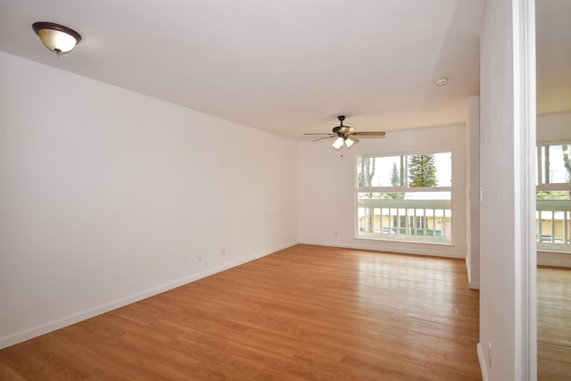 spare room with ceiling fan and light hardwood / wood-style floors