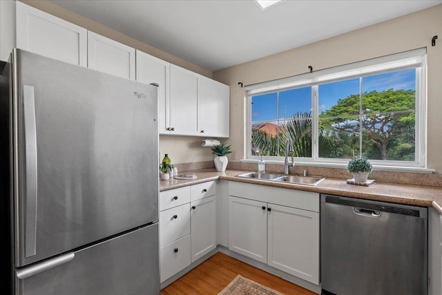22 Kai Makani Loop Unit 201, Kihei, HI 96753 - kitchen with stainless steel appliances, a sink, healthy amount of natural light, and white cabinets