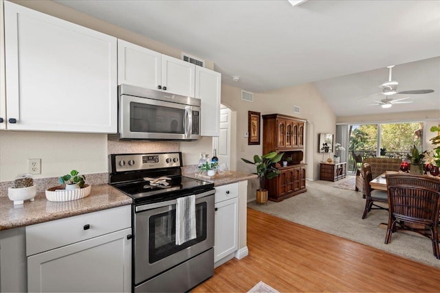 22 Kai Makani Loop Unit 201, Kihei, HI 96753 - kitchen featuring appliances with stainless steel finishes, lofted ceiling, white cabinets, a ceiling fan, and light wood-style floors