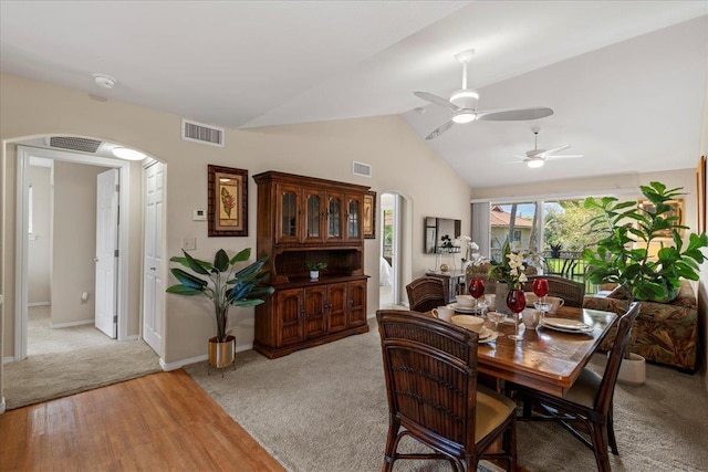 22 Kai Makani Loop Unit 201, Kihei, HI 96753 - dining room featuring arched walkways, vaulted ceiling, a ceiling fan, light colored carpet, and light wood-type flooring