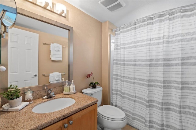 22 Kai Makani Loop Unit 201, Kihei, HI 96753 - bathroom featuring vanity, toilet, and curtained shower