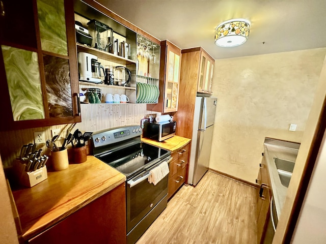 kitchen featuring appliances with stainless steel finishes and light wood-type flooring