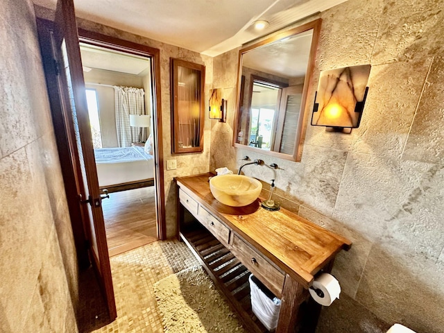 bathroom featuring tile walls and vanity