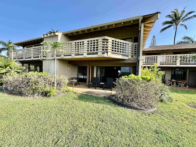 rear view of property with a lawn and a patio area