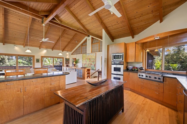 kitchen featuring beamed ceiling, high vaulted ceiling, appliances with stainless steel finishes, wooden ceiling, and light hardwood / wood-style floors