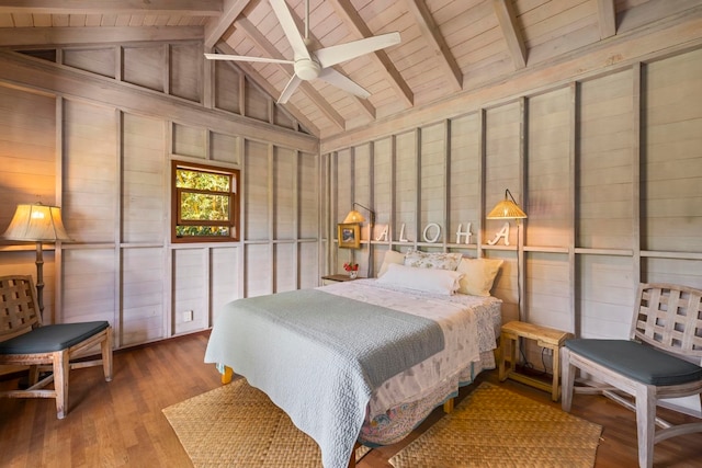 bedroom featuring ceiling fan, vaulted ceiling with beams, wood walls, and hardwood / wood-style floors