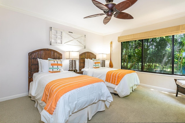 carpeted bedroom featuring ceiling fan and ornamental molding