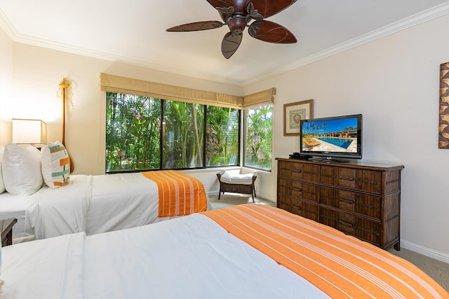 carpeted bedroom with ceiling fan and ornamental molding