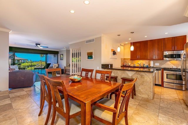 dining area with ceiling fan and ornamental molding