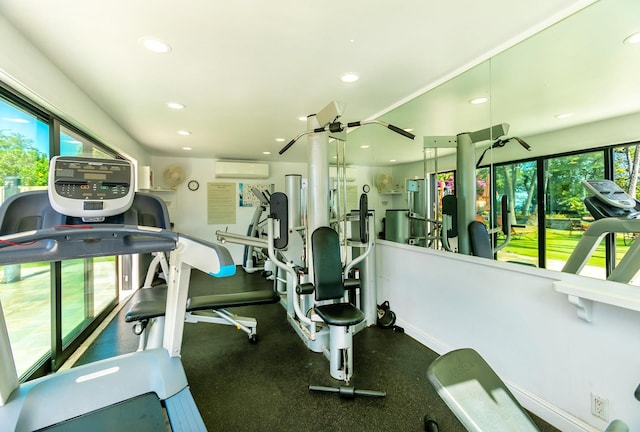 gym featuring plenty of natural light and a wall mounted air conditioner