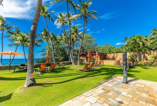 view of home's community featuring a yard and a water view