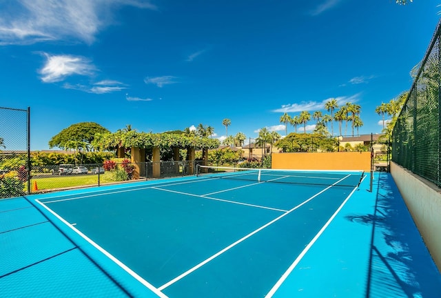 view of tennis court with basketball hoop