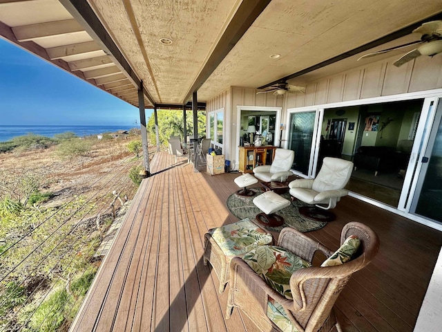 wooden terrace with ceiling fan and a water view