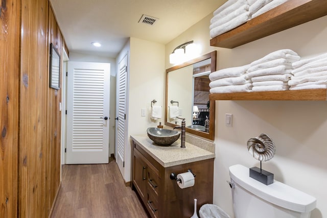 bathroom featuring hardwood / wood-style floors, vanity, and toilet