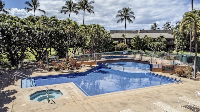 view of pool featuring a hot tub and a patio area