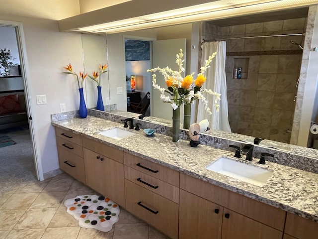 bathroom featuring a shower with shower curtain, tile patterned flooring, and vanity