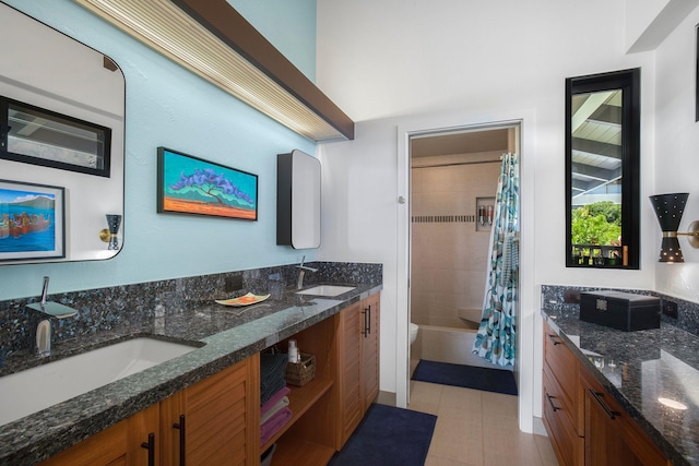 bathroom with vanity, shower / bath combo with shower curtain, and tile patterned floors