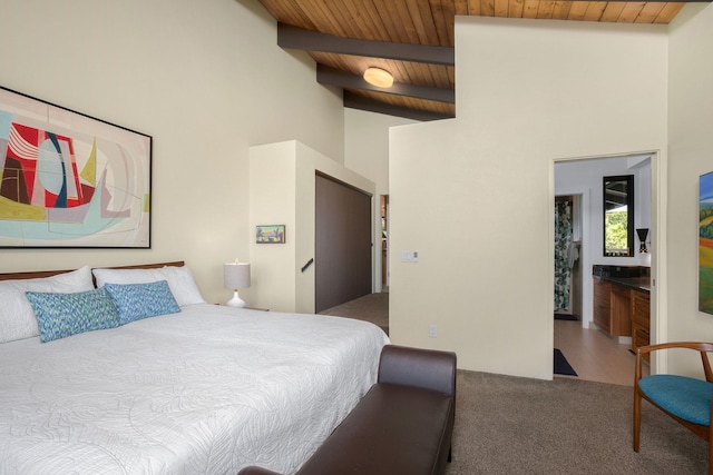 carpeted bedroom with high vaulted ceiling, connected bathroom, beam ceiling, and wooden ceiling