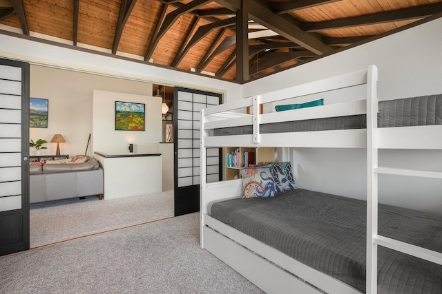 carpeted bedroom with lofted ceiling with beams and wooden ceiling