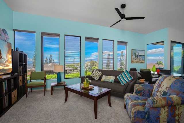 carpeted living room featuring ceiling fan