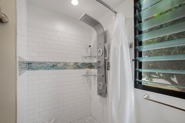 interior details featuring a shower with shower curtain