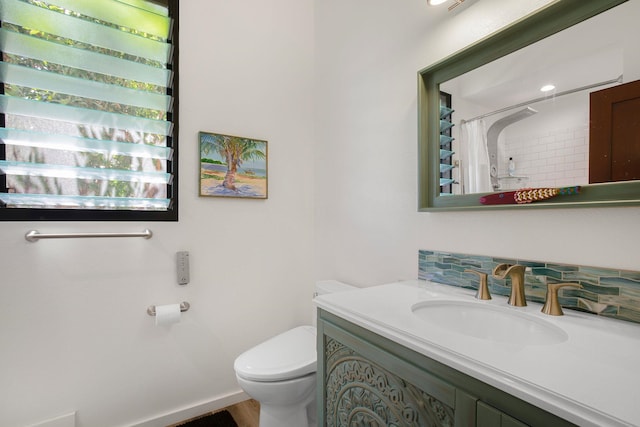 bathroom featuring walk in shower, vanity, and toilet