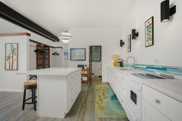 kitchen featuring electric range, white cabinetry, a kitchen bar, decorative light fixtures, and dark hardwood / wood-style flooring