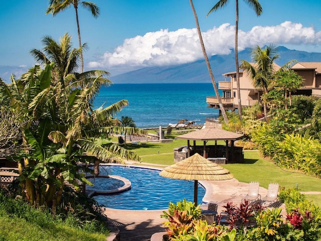 view of swimming pool with a gazebo, a yard, and a water view