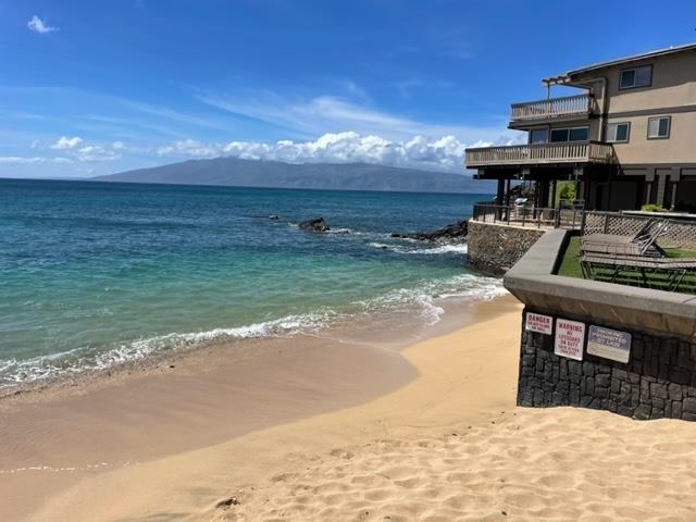 property view of water with a mountain view and a beach view