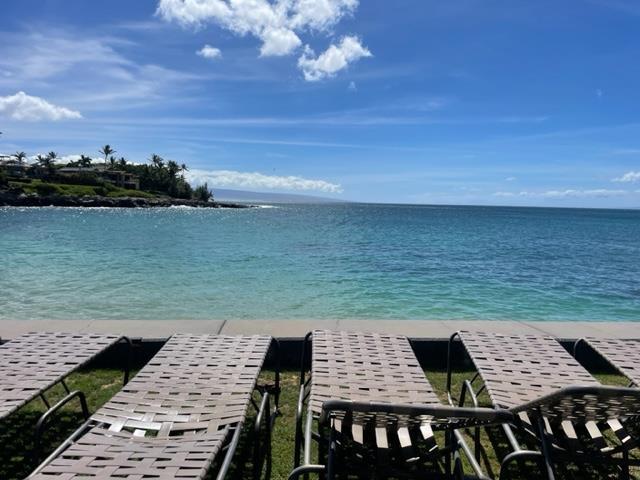 view of dock featuring a view of the beach and a water view