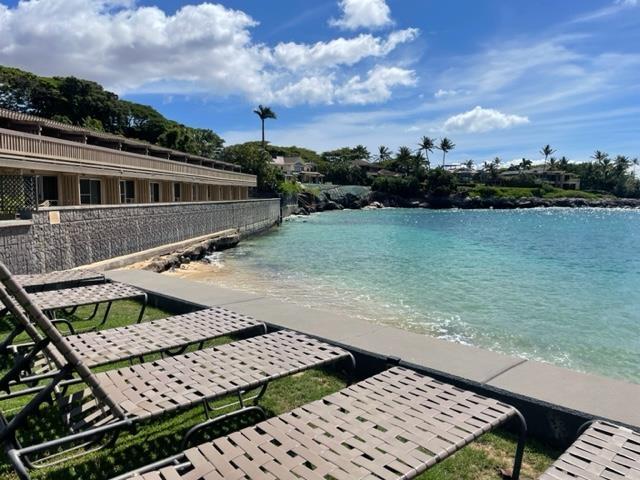 view of pool with a water view and a view of the beach