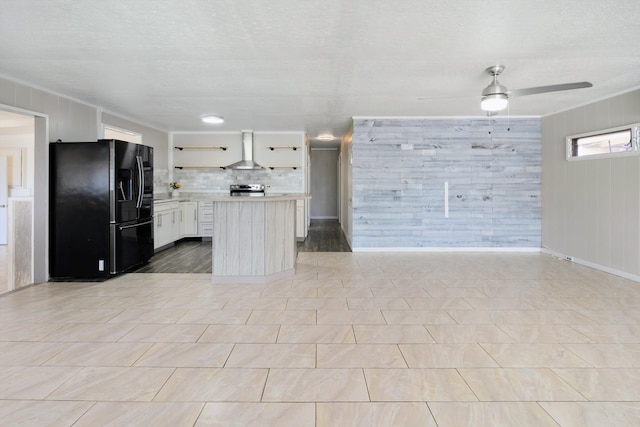 kitchen featuring open shelves, stainless steel electric range, wall chimney exhaust hood, light countertops, and black refrigerator with ice dispenser