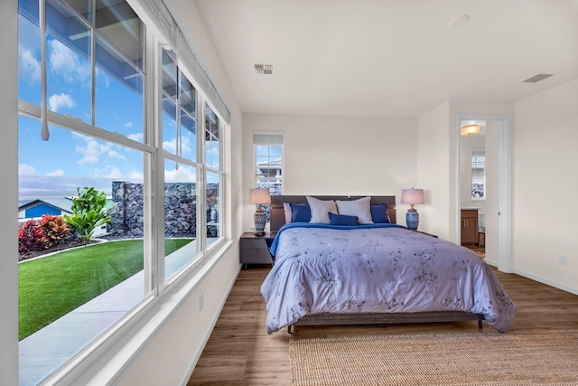bedroom featuring baseboards and wood finished floors