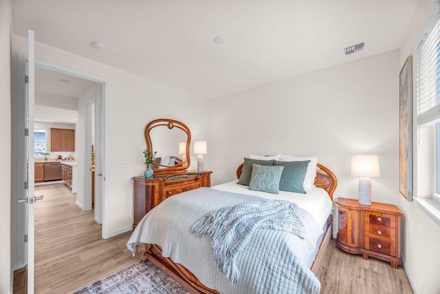 bedroom with light wood-style flooring and baseboards