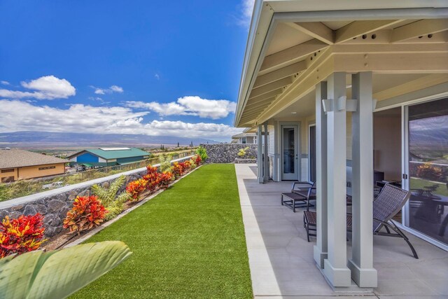 view of grassy yard with a patio