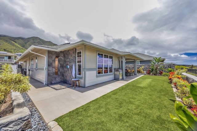 back of house with a patio and a mountain view