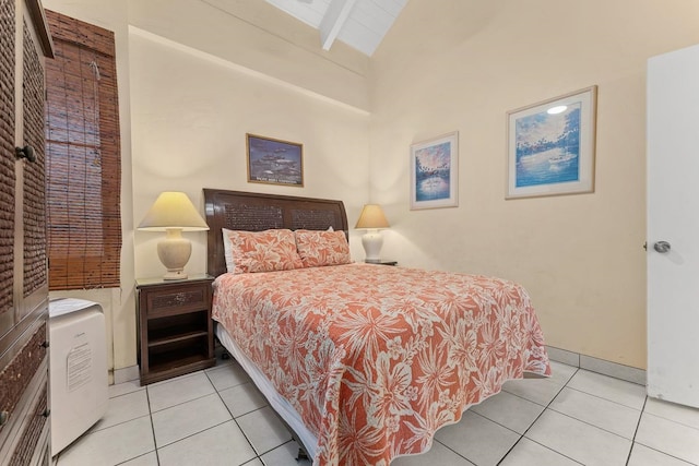 bedroom with lofted ceiling with beams and light tile patterned floors