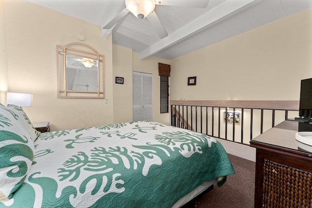 carpeted bedroom featuring a closet, ceiling fan, and lofted ceiling with beams