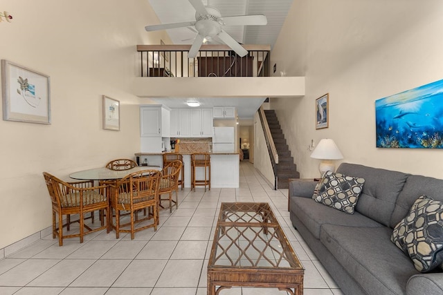 tiled living room with high vaulted ceiling and ceiling fan