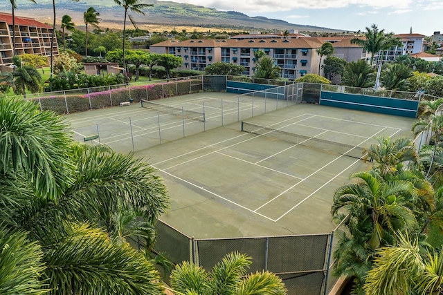 view of tennis court with a mountain view