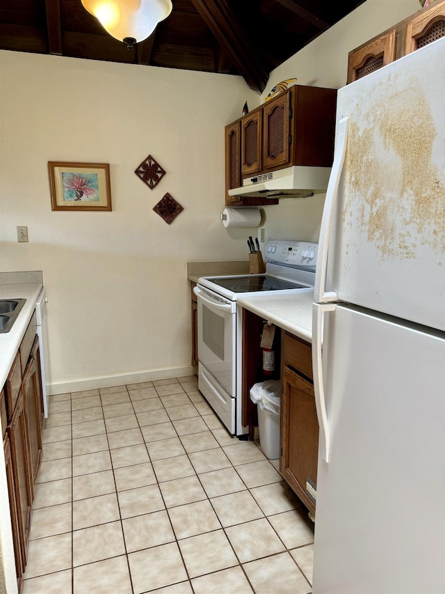 kitchen featuring light tile patterned flooring and white appliances