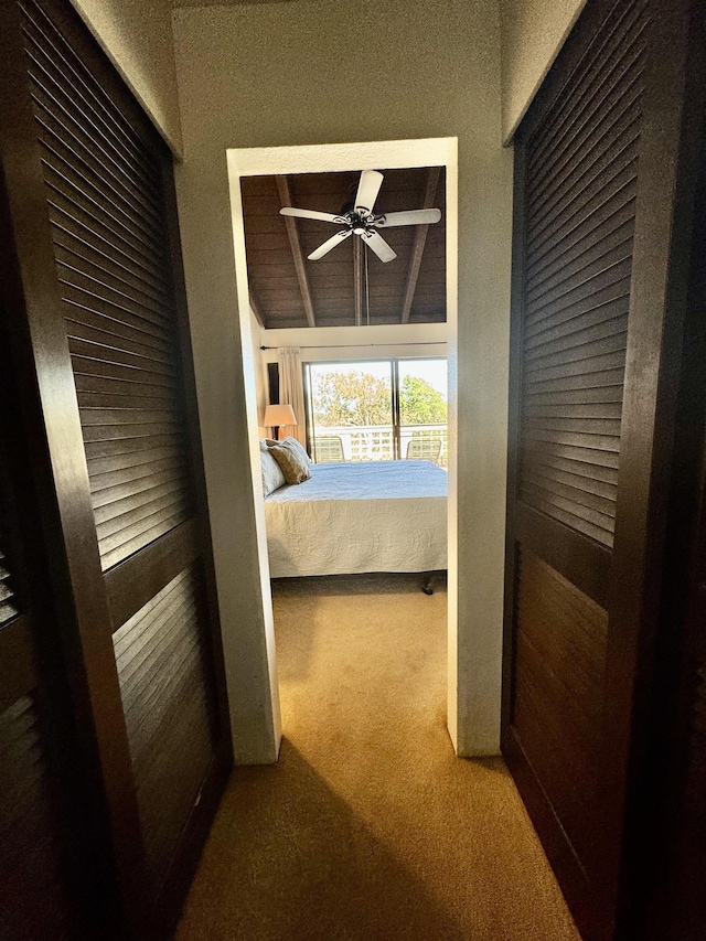 bedroom featuring ceiling fan, carpet floors, and lofted ceiling