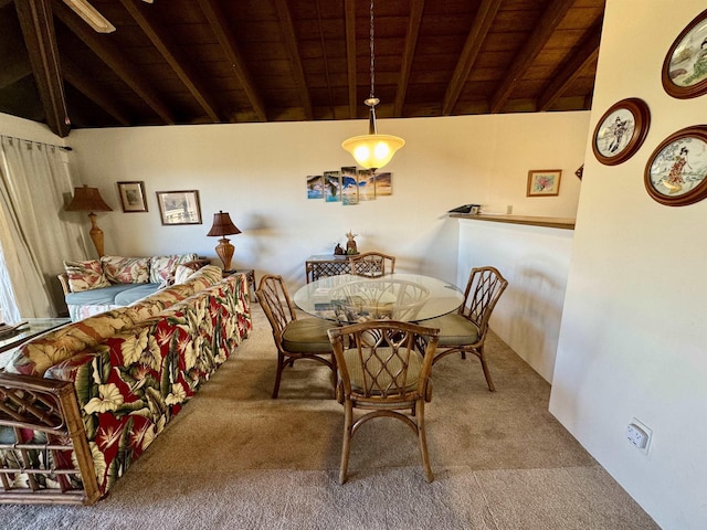 dining space with carpet flooring, vaulted ceiling with beams, and wooden ceiling