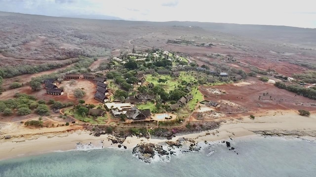 birds eye view of property featuring a beach view and a water view