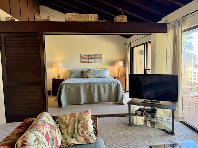 carpeted bedroom with lofted ceiling with beams