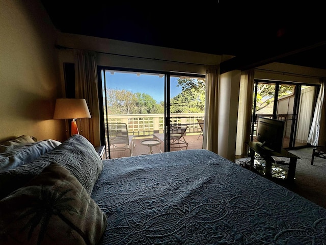 bedroom with access to exterior and carpet floors